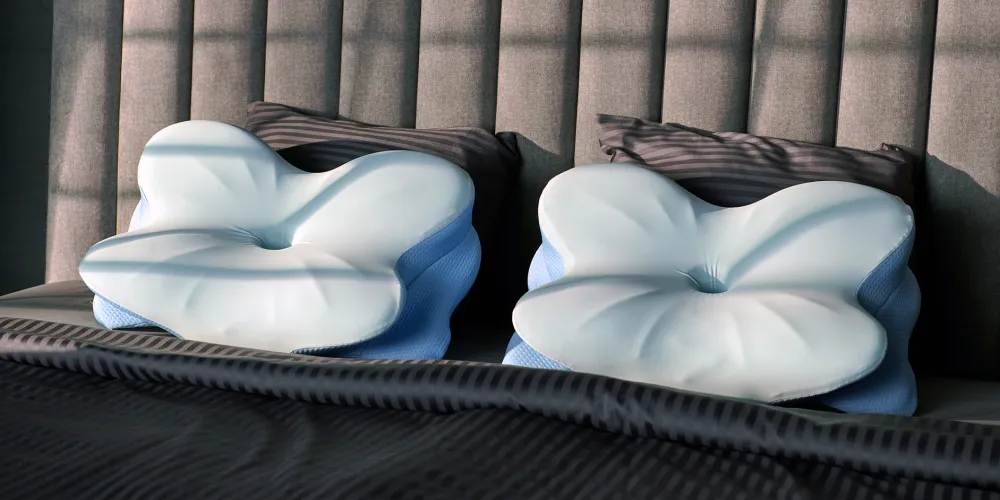 Two Derila ERGO pillows side by side on a bed, showing the contoured top surface and side wings
